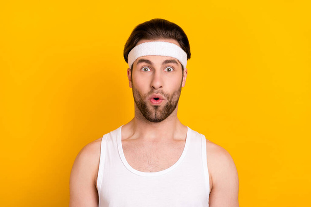 Portrait of attractive amazed guy sportsman pout lips news reaction isolated over bright yellow color background - Photo, Image