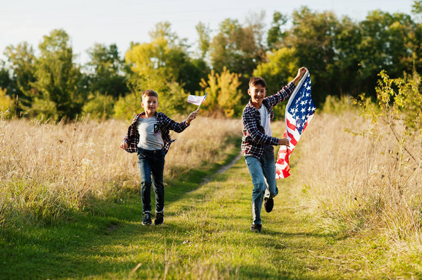 Two brothers running with USA flag. America holiday. Proud to be children of country. - Photo, image