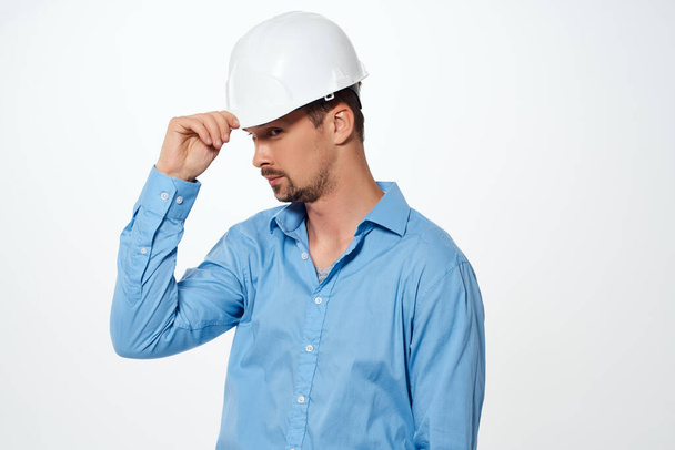 male builder with drawings in hand hand gesture light background - Photo, Image