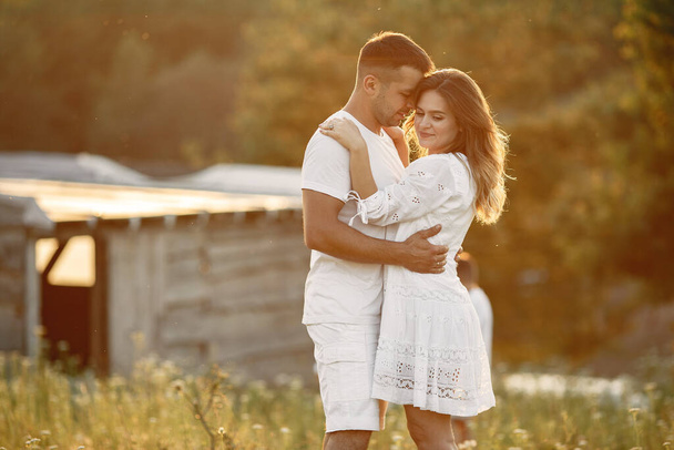 Beautiful couple spend time on a summer field - Zdjęcie, obraz
