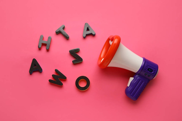 Toy megaphone and letters on color background - Foto, Imagen