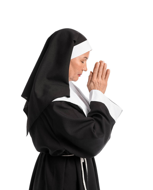 Mature nun praying on white background - Foto, imagen