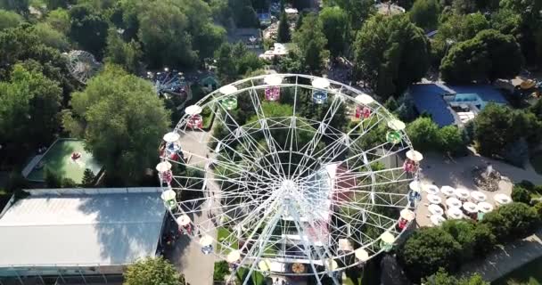 A city Park with rides and a Ferris wheel. - Footage, Video