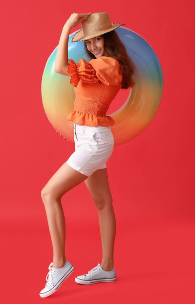 Young woman with inflatable ring on color background - Foto, Bild