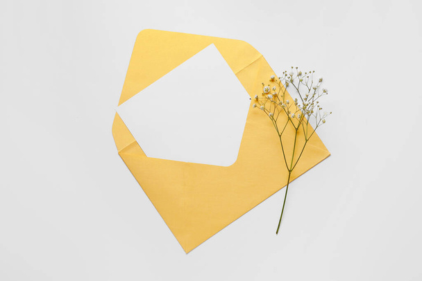 Envelope with blank card and flowers on white background - Photo, image