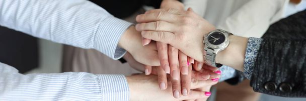 Closeup of many folded hands of businessmen in office - Foto, Imagem