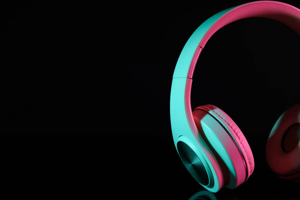 Modern headphones on dark background, closeup - Photo, Image