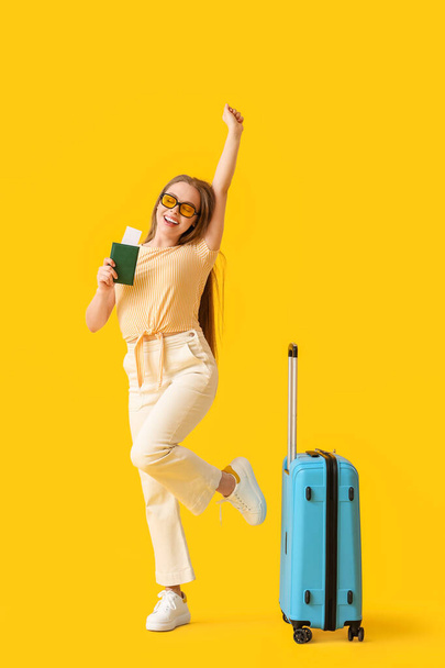Happy female tourist on color background - Photo, Image