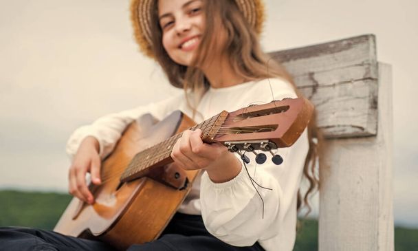 have fun on party. guitar player or guitarist. singer with guitar. girl playing guitar. musical school concept. country music. music is my life. child with acoustic string instrument. selective focus - Zdjęcie, obraz