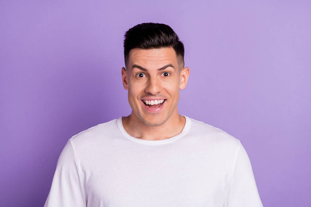 Photo of young handsome guy happy positive smile amazed excited shocked surprised news isolated over violet color background - Φωτογραφία, εικόνα
