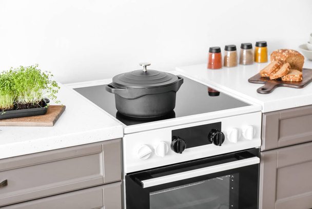 Cooking pot on electric stove in kitchen - Photo, Image