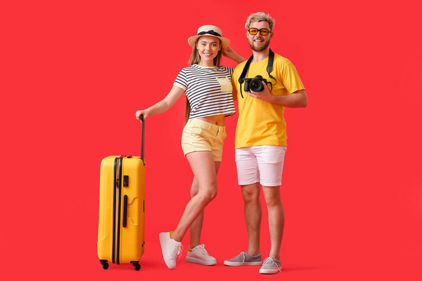 Couple of tourists on color background - Photo, Image