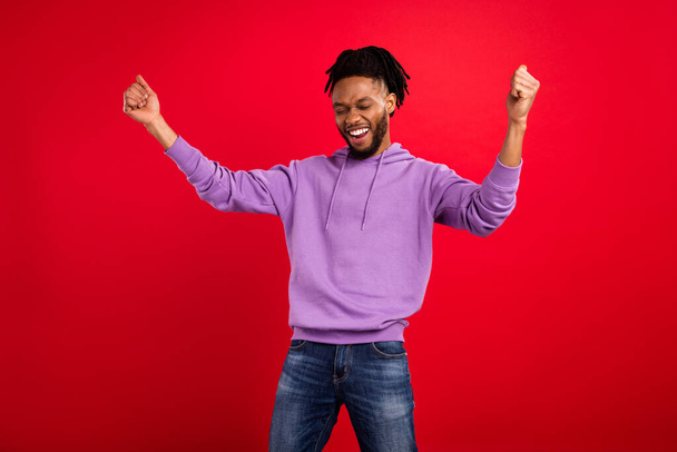 Photo portrait man smiling overjoyed gesturing like winner isolated vibrant red color background - Photo, image