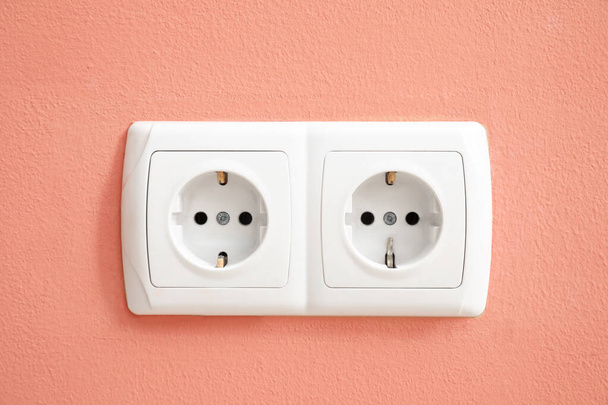 Electric socket on color wall - Photo, Image