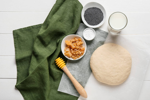 Fresh dough for poppy seed bun and ingredients on light wooden background - Photo, Image