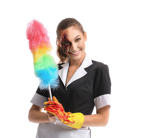 Woman dressed for Halloween as chambermaid with dust brush on white background - Photo, Image