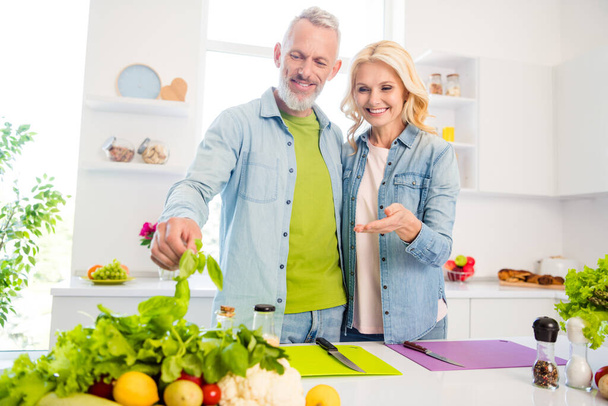 Photo of two cheerful good mood mature married couple making breakfast prepare meal vegan ingredient indoors - Zdjęcie, obraz