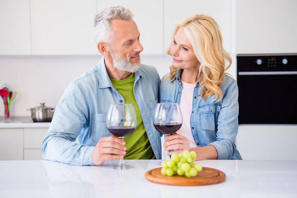 Photo of good mood positive smiling dreamy married couple have date at home drinking wine eat appetizer grape - Fotó, kép