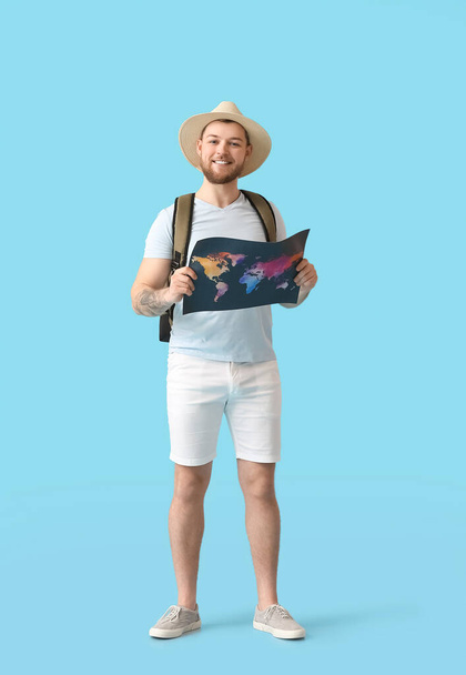 Male tourist with map on color background - Fotoğraf, Görsel