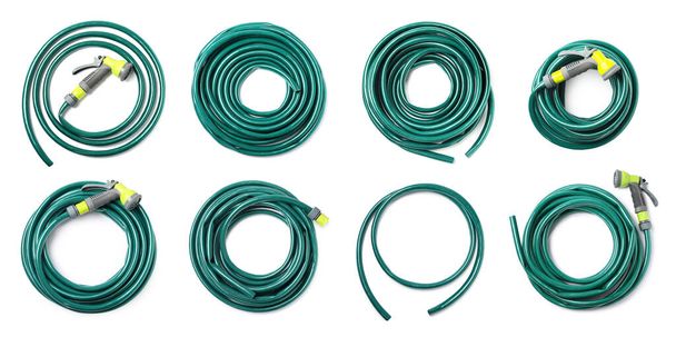 Set with green rubber watering hoses on white background, top view. Banner design - Foto, immagini