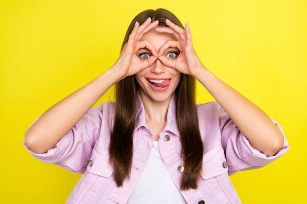 Portrait of attractive cheerful girl showing ok-sign like glasses grimacing fooling isolated over bright yellow color background - 写真・画像