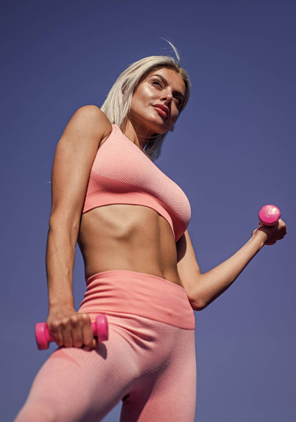 sexy woman training with dumbbells on sky background, sport - Φωτογραφία, εικόνα