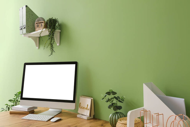 Lugar de trabajo moderno con ordenador cerca de la pared de color - Foto, Imagen