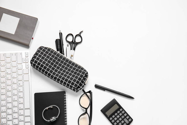 Pencil case, keyboard, accessories and stationery on white background - 写真・画像
