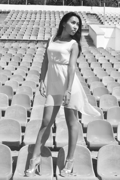 Asian Model Posing at the stadium standing on the bright seats - Photo, Image