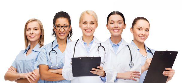 smiling female doctors and nurses with stethoscope - Foto, imagen