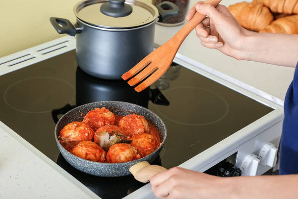 Woman cooking meatballs in kitchen - Photo, Image