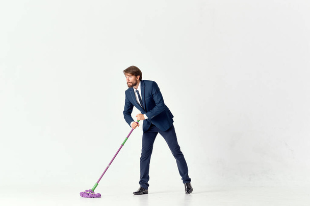business man in a suit washes the floors with a mop manager - Photo, image