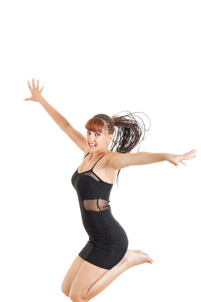 smiling young woman jumping in the air with open arms - Foto, immagini