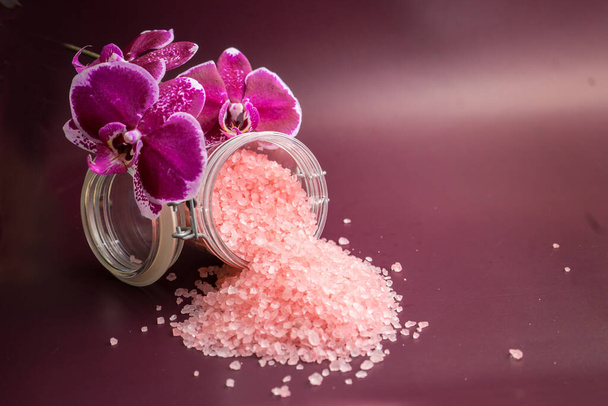 Pink bath salt with orchid flower on vinous background . High quality photo - Photo, Image