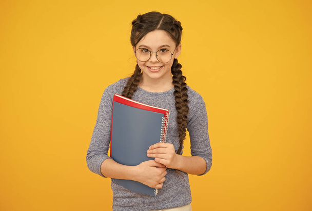 Private lessons. Focus on education. Private schooling. Cute smiling schoolgirl. Girl little schoolgirl. Pupil with braids going to school. Schoolgirl daily life. School club. Library concept - Фото, изображение