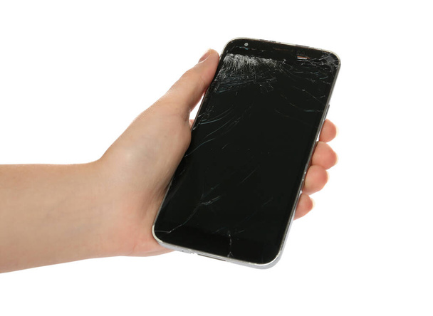 Woman holding damaged smartphone on white background, closeup. Device repairing - Photo, Image