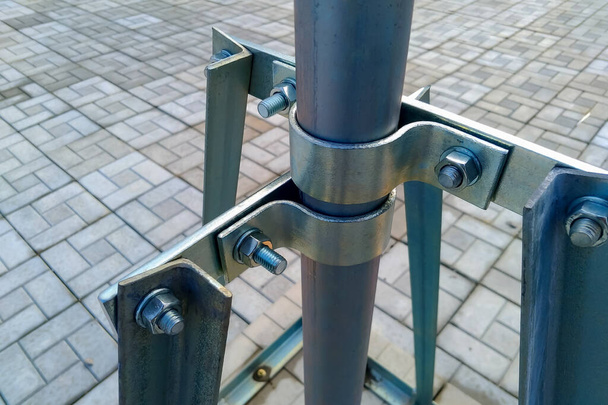 Mounting elements of metal structures on bolts and steel clamps made of galvanized steel. - Photo, Image