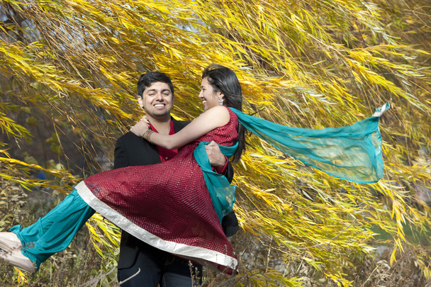 Young Indian Man Carrying His Bride - Foto, afbeelding