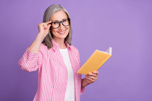 Profile side photo of mature woman happy smile red book materials study isolated over purple color background - Φωτογραφία, εικόνα