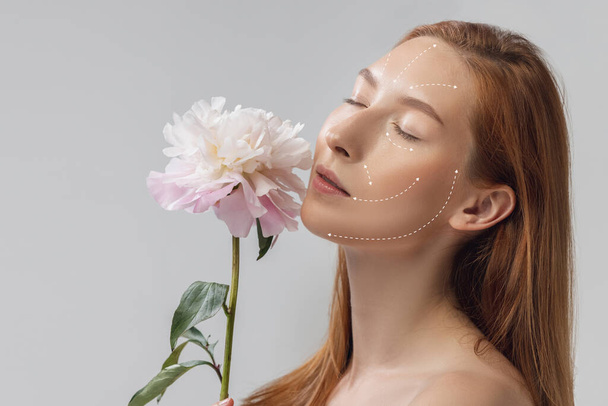 Close-up portrait of young, beautiful and healthy woman with arrows on her face. The spa, surgery, face lifting and skin care concept - Foto, Imagen
