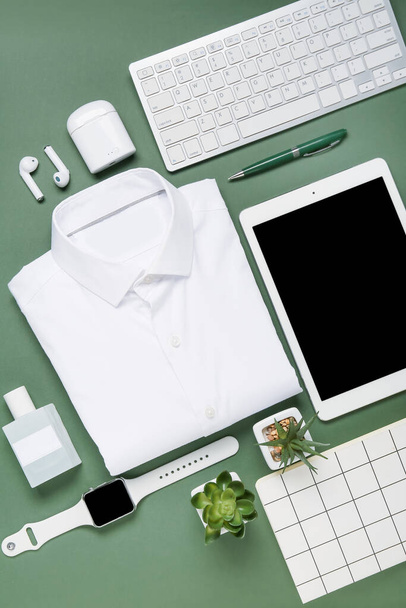 Stylish shirt and modern gadgets on color background - Photo, Image
