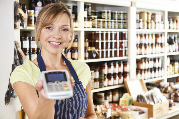 Sales Assistant In Food Store With Credit Card Machine  - Foto, Imagen