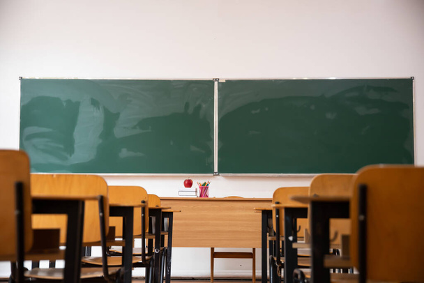 Back to School Concept. Empty classroom with chairs, desks and chalkboard. - Фото, зображення