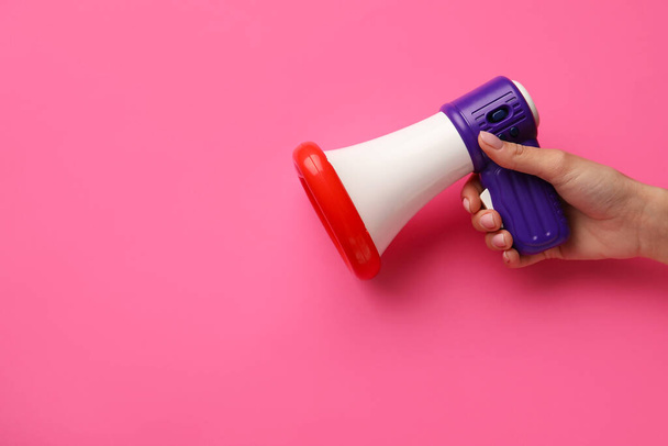 Woman with toy megaphone on color background - Photo, Image