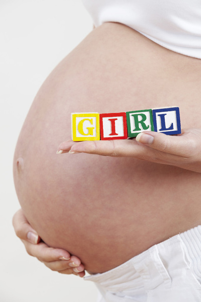 Close Up Of Pregnant Woman Holding Blocks Spelling Baby - Fotó, kép