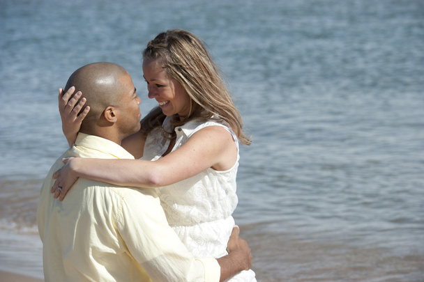 Interracial couple on the beach - Фото, изображение