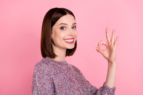 Photo of positive nice lady show okey sign approving beaming smile wear knitted sweater isolated pink color background - Foto, Imagem