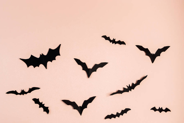 Halloween concept. Bats and spiders on a pink background. Festive decorations. - Fotografie, Obrázek