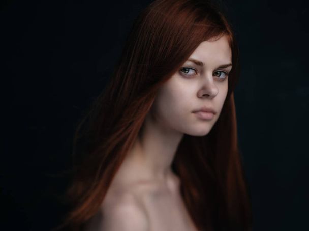 red-haired woman naked shoulders dark background glamor - Φωτογραφία, εικόνα