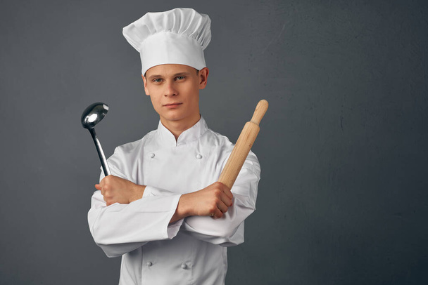 man in chefs uniform frying pan in hands cooking food isolated background - Fotoğraf, Görsel